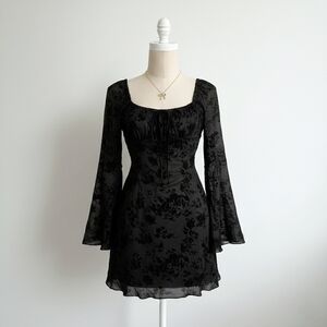 Elegant Black Floral Dress With Ruffle And Bow Neckline And Flared Sleeves